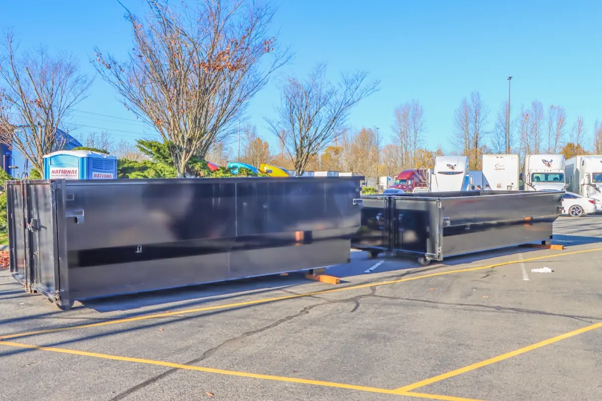 Professional dumpster rental service with roll-off container on residential driveway in Sunrise Manor